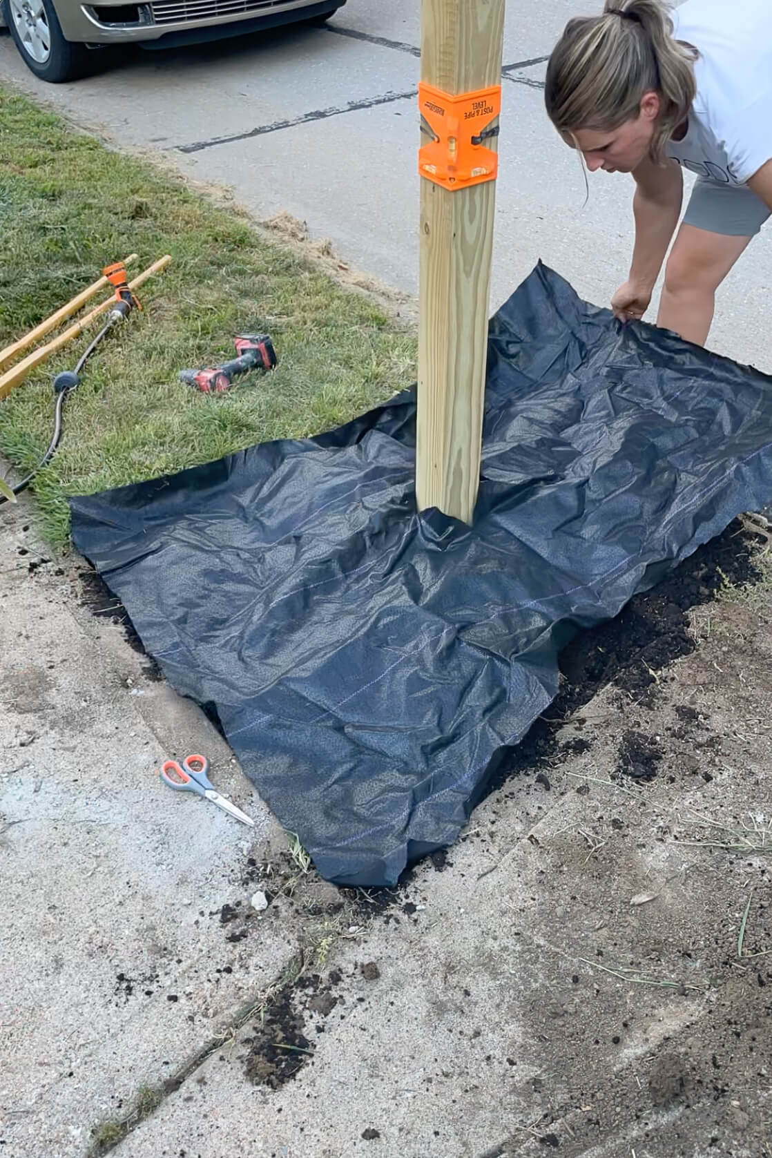 Using weed barrier in a flower bed. 